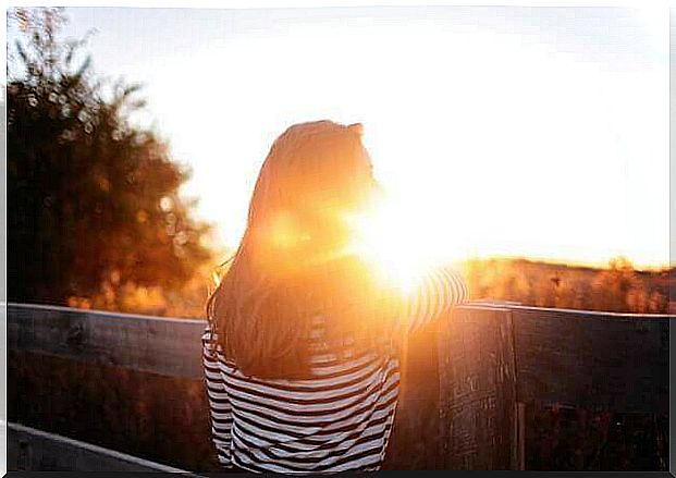 woman facing the sunset