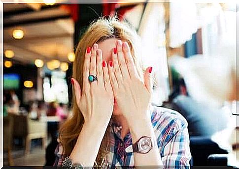 woman covering her face