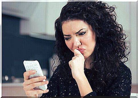 Confused woman with message on cell phone