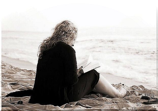 woman reading on the beach