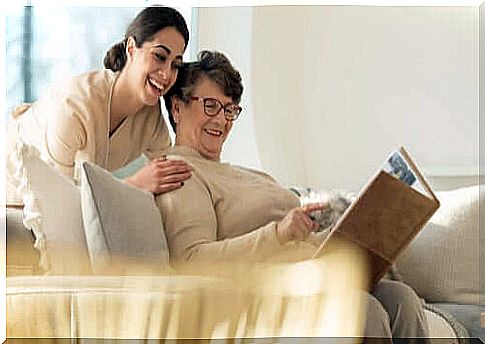 Daughter watching photos with an elderly mother