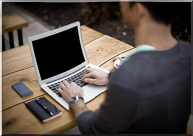 Man working with smartphone beside