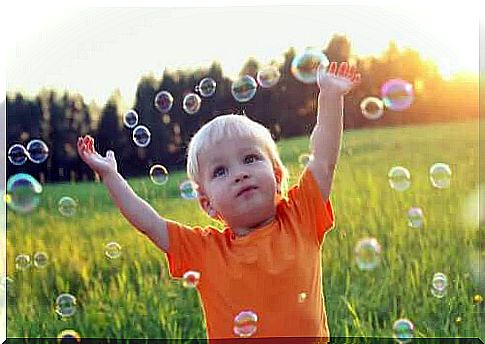 child playing with soap bubbles