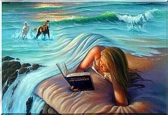 woman reading covered by the ocean