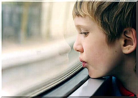 Upset boy looking out the window